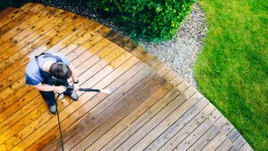 man cleaning terrace with a pressure washer